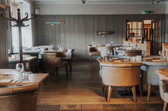 The Boatshed Restaurant in Royal Hotel, featuring stylish furniture and inviting ambiance.