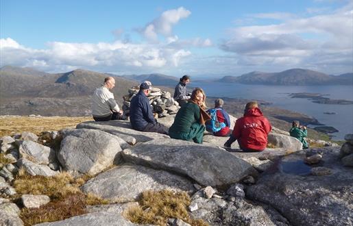 Hidden Hebrides group of people sitting on top of a mountain