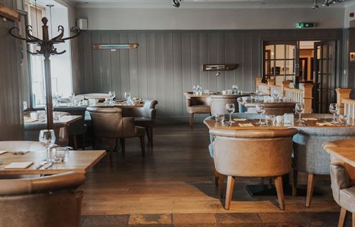 The Boatshed Restaurant in Royal Hotel, featuring stylish furniture and inviting ambiance.