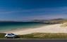 The Beach House car parked beside beach