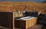 Hebrides House hot tub against stone wall